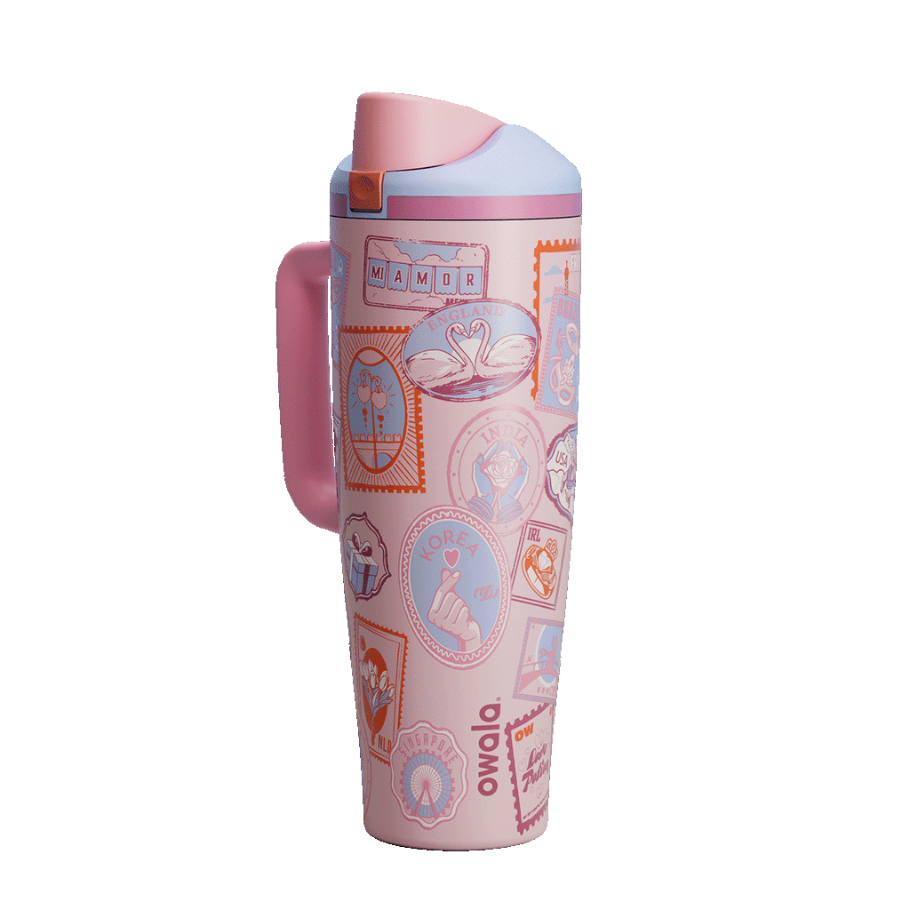 Owala FreeSip Tumbler in Sending Love, pink flip cap open exposing pink FreeSip spout with orange accent over patterned body and pink side handle